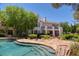 Stunning pool and spa with flagstone patio and rock waterfall features at 66 Innisbrook Ave, Las Vegas, NV 89113