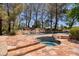 Resort-style pool and spa with flagstone patio and natural rock formations at 66 Innisbrook Ave, Las Vegas, NV 89113