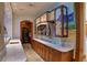 Custom wet bar with marble countertop, wine storage, and hand-painted mural at 66 Innisbrook Ave, Las Vegas, NV 89113