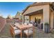 Virtually staged backyard with patio furniture and a built-in grill at 7716 Gallego Plains Dr, Las Vegas, NV 89113