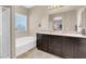 Bathroom with double vanity, soaking tub, and walk-in shower at 7906 Woolly St, Las Vegas, NV 89149