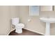 Clean and simple bathroom with pedestal sink and toilet at 7906 Woolly St, Las Vegas, NV 89149