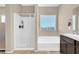 Bathroom with a shower, bathtub, and vanity at 7906 Woolly St, Las Vegas, NV 89149