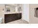 Double vanity bathroom with dark brown cabinets and a soaking tub at 7906 Woolly St, Las Vegas, NV 89149