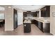 Kitchen with island, stainless steel appliances, and granite countertops at 7906 Woolly St, Las Vegas, NV 89149