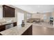 Open kitchen with granite countertops and stainless steel appliances at 7906 Woolly St, Las Vegas, NV 89149