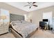 Spacious main bedroom with a king-size bed, large TV, and workspace at 7906 Woolly St, Las Vegas, NV 89149