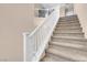 Staircase with white railing and carpeted steps at 7906 Woolly St, Las Vegas, NV 89149