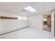 Spacious basement room with tile flooring and built-in shelving at 875 Cooper St, Overton, NV 89040