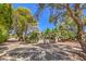 House exterior showcasing mature trees and a gravel driveway at 875 Cooper St, Overton, NV 89040