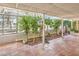 Relaxing sunroom featuring terracotta tile floor and lush plants at 875 Cooper St, Overton, NV 89040