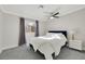 Bright bedroom with a queen bed, gray carpet, and ceiling fan at 8870 W Craig Rd, Las Vegas, NV 89129