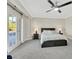 Well-lit bedroom featuring a comfortable bed and patio access at 8870 W Craig Rd, Las Vegas, NV 89129