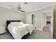 Spacious bedroom with queen bed, gray carpet, and access to another room at 8870 W Craig Rd, Las Vegas, NV 89129