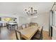 Bright dining room with chandelier and wood table, view to kitchen at 8870 W Craig Rd, Las Vegas, NV 89129