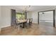 Bright dining room with chandelier and wood table, view to kitchen at 8870 W Craig Rd, Las Vegas, NV 89129