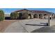 Single-story home with a large driveway and mature landscaping at 8870 W Craig Rd, Las Vegas, NV 89129