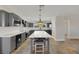 Modern kitchen with gray cabinets, quartz island, and pendant lighting at 8870 W Craig Rd, Las Vegas, NV 89129