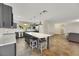 Modern kitchen with gray cabinets, quartz island, and pendant lighting at 8870 W Craig Rd, Las Vegas, NV 89129