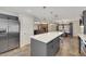 Modern kitchen with gray cabinets, quartz island, and pendant lighting at 8870 W Craig Rd, Las Vegas, NV 89129