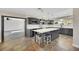 Modern kitchen with gray cabinets, quartz island, and pendant lighting at 8870 W Craig Rd, Las Vegas, NV 89129