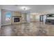 Living room with a fireplace, tile floors, and open concept to kitchen at 8870 W Craig Rd, Las Vegas, NV 89129