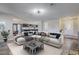 Spacious living room with a large sectional sofa and a view of the kitchen at 8870 W Craig Rd, Las Vegas, NV 89129