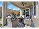 Covered patio with seating area and fire pit at 8929 Cassia Winds St, Las Vegas, NV 89166