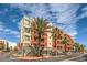 Modern building exterior with palm trees and parking at 91 E Agate Ave # 401, Las Vegas, NV 89123