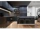 Modern kitchen with dark cabinetry, marble countertops, and bar seating at 924 S First St # 406, Las Vegas, NV 89101