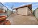 Home's backyard with covered patio area, with brick trim and concrete at 111 Manganese St, Henderson, NV 89015