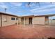 Home's backyard with covered patio area, with brick trim and concrete at 111 Manganese St, Henderson, NV 89015