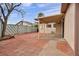 Home's backyard with covered patio area, with brick trim and concrete at 111 Manganese St, Henderson, NV 89015