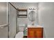 Standard bathroom with shower, toilet, and sink with small wood cabinet at 111 Manganese St, Henderson, NV 89015