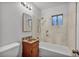 A clean bathroom with a bathtub, shower, new vanity and tile flooring at 111 Manganese St, Henderson, NV 89015