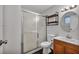 Standard bathroom with shower, toilet, and sink with small wood cabinet at 111 Manganese St, Henderson, NV 89015