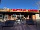 Exterior view of Water Street Tavern, featuring a rustic wood design, outdoor seating, and a lively atmosphere at 111 Manganese St, Henderson, NV 89015