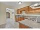 A tidy kitchen featuring stainless steel appliances, granite counters, and tile flooring at 111 Manganese St, Henderson, NV 89015