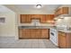 Traditional kitchen featuring wooden cabinets, granite countertops, and tile flooring at 111 Manganese St, Henderson, NV 89015
