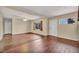 Bright and airy living room featuring neutral paint, hardwood floors and plentiful natural light from the windows at 111 Manganese St, Henderson, NV 89015