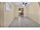 Inviting living room with neutral walls, tile flooring, and view to kitchen at 111 Manganese St, Henderson, NV 89015