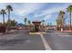 Gated community entrance with palm trees and well-maintained landscaping, offering security and exclusivity at 1158 Safari Creek Dr, Henderson, NV 89002