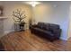 Spacious living room with wood flooring, tree wall art, and comfortable seating at 1321 Cinder Rock Dr # 202, Las Vegas, NV 89128