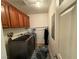 Laundry room with washer, dryer, and overhead cabinets at 1571 Plaza Centre Dr # 102, Las Vegas, NV 89135