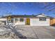 Updated single-story home with a bright yellow door and fresh landscaping at 1704 Ferrell St, Las Vegas, NV 89106