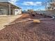 Spacious backyard with gravel and covered patio at 1819 Bassler St, North Las Vegas, NV 89030
