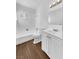 Bathroom with white vanity, tub, and flooring at 1819 Bassler St, North Las Vegas, NV 89030