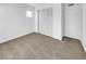 Bright bedroom featuring neutral carpeting and double door closet at 1819 Bassler St, North Las Vegas, NV 89030