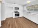 Modern kitchen with white cabinets and stainless steel appliances at 1819 Bassler St, North Las Vegas, NV 89030