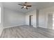 Bright bedroom featuring wood floors, ceiling fan, and closet at 2140 Upland Ave, Pahrump, NV 89048